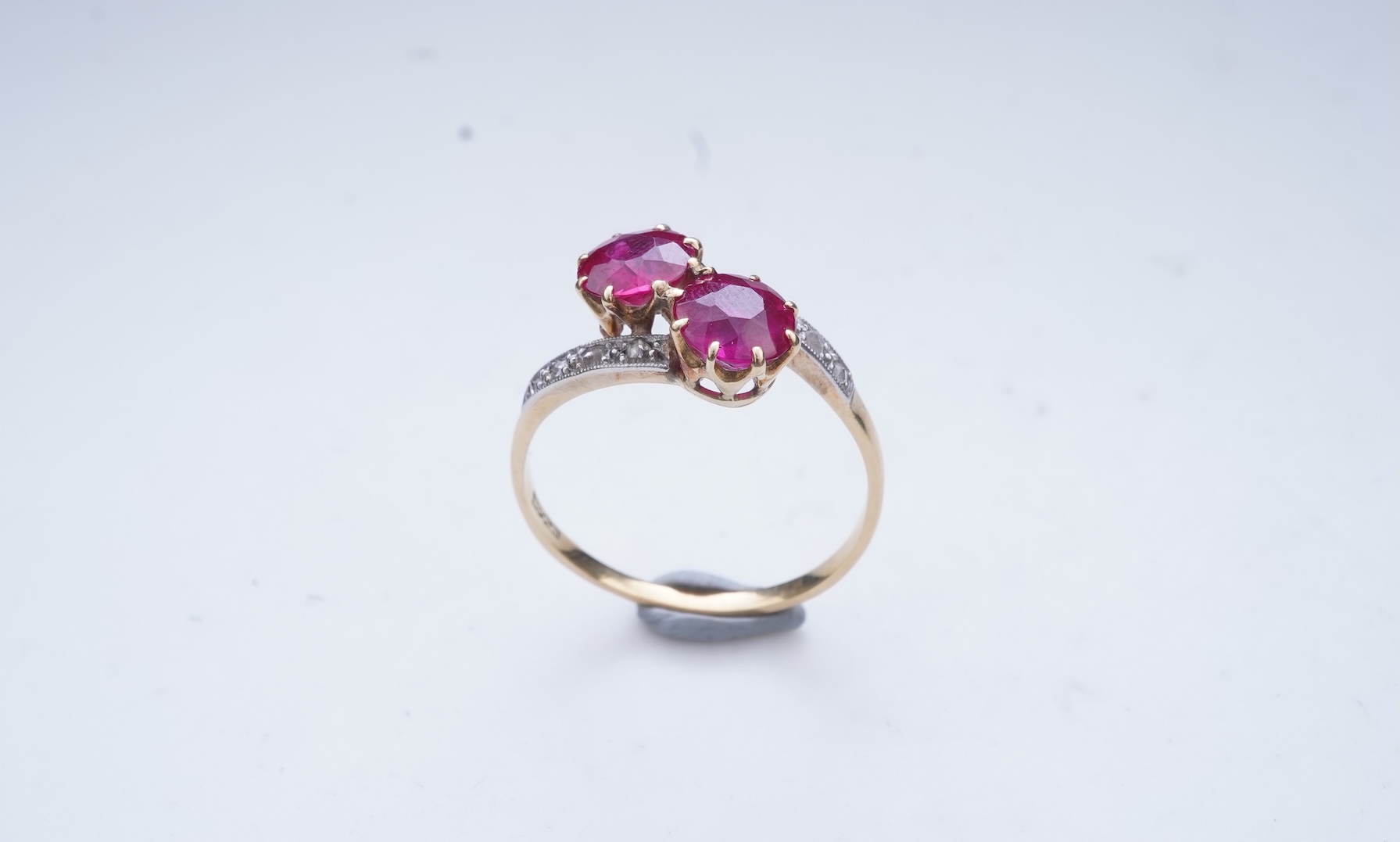 A synthetic ruby and diamond 'toi-et-moi' ring, early 20th century